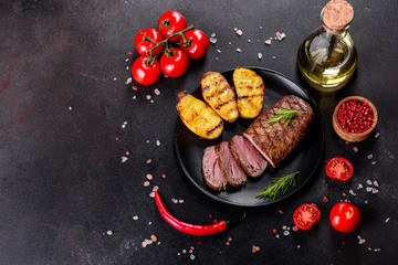 Ribeye steak with potatoes, onions and cherry tomatoes