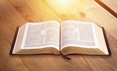 Fototapeta premium Open vintage christian bible on the desk