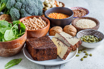 Vegan sources of protein. Tofu, chickpeas, lentils, nuts, spinach and broccoli - vegetable proteins.
