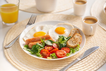 fried eggs, sausages and fresh vegetables  for breakfast