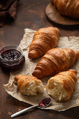 Freshly baked croissants with berries jam