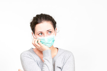 caucasian brunette woman in protective medical mask on face protection for spreading of disease virus SARS-CoV-2, Coronavirus, COVID-19. white background