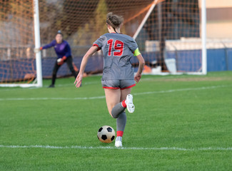 High school girl competing in a soccer match in south Texas