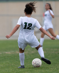 High school girl competing in a soccer match in south Texas © Joe