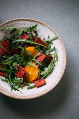 vegetarian salad with beets, orange, crackers, olive oil