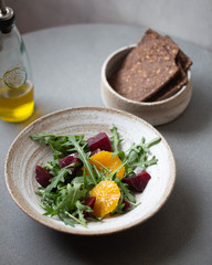 vegetarian salad with beets, orange, crackers, olive oil