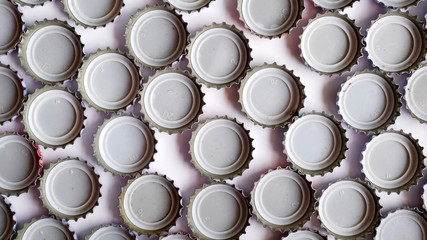 pile of bottle caps white background. beer caps