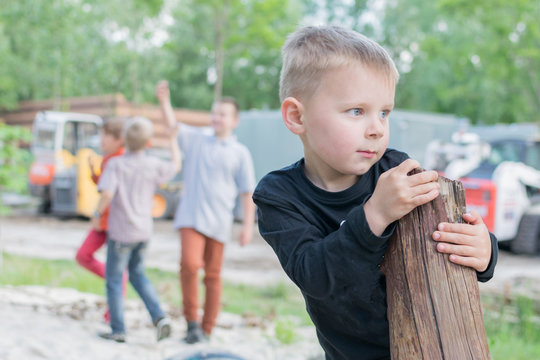 A little boy is playing alone on the playground. The problem of socialization of the child in the team. The concept of autism, closeness, unfriendliness.