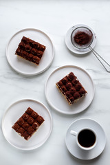 Tiramisu with coffee on white marble background