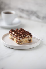 Tiramisu with coffee on white marble background