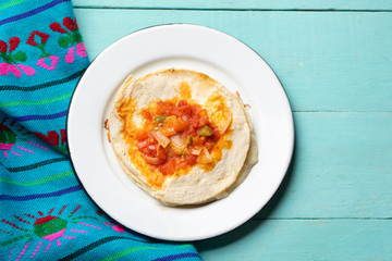 Mexican quesadilla with corn tortilla and piquant sauce also called 