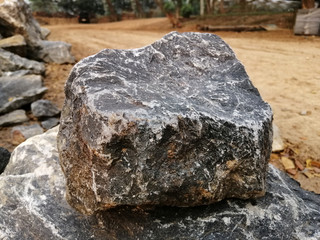 Limestone rock on nature background. Limestone is a sedimentary rock composed mostly of the mineral calcite, It is a basic building block of the construction industry.