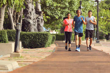 Fototapeta premium An old man in Asia is jogging with his son and daughter in the morning.