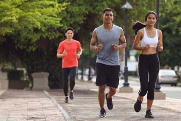 Young lovers are jogging in the city in the evening.