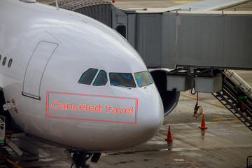 Canceled travel quarantine global pandemic corona virus covid-19 Airliner being prepared for boarding and takeoff on airport docked to terminal and serviced