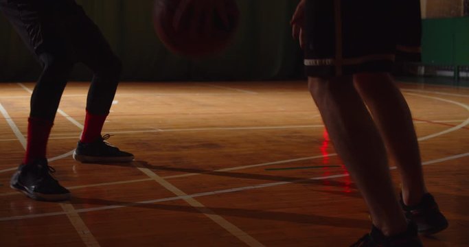 Two young basketball players play basket ball competition amateurs hall sports parquet dribbling stamina
