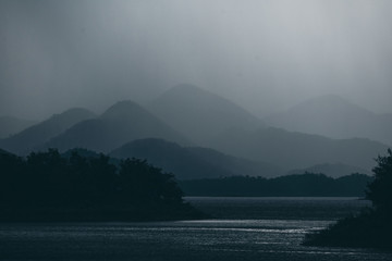 dark tone of mountain layers with lake  tropical forest