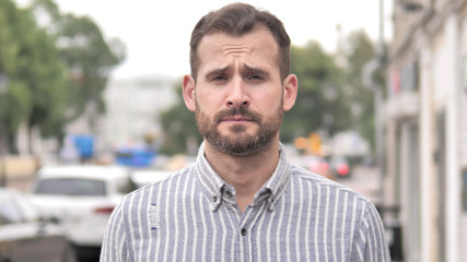 Naklejka premium Outdoor Portrait of Upset Beard Casual Man
