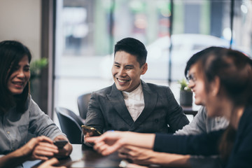 business people using smartphone at meeting table