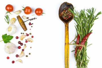 A mixture of peppers in a wooden spoon, fresh vegetables and seasonings used in cooking isolated on...