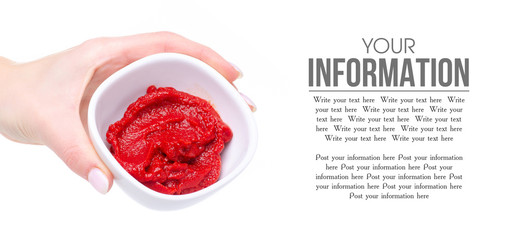 Tomato paste in white bowl in hand on white background isolation