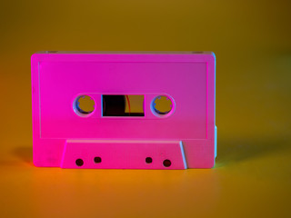 Obraz premium Audio cassette tape vintage analog recording medium from 1970's on yellow background