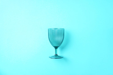 Champagne glass on blue background with copy space for text. Top view. Holiday and celebration concept.