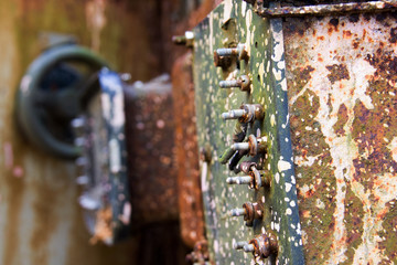 Screws on a rusty machine in an abandoned factory