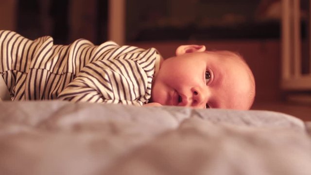 Portrait of a cute newborn baby on the floor in the bedroom