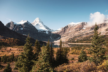 Scenery of mount Assiniboine with lake Magog and blue sky in autumn forest on provincial park at British Columbia