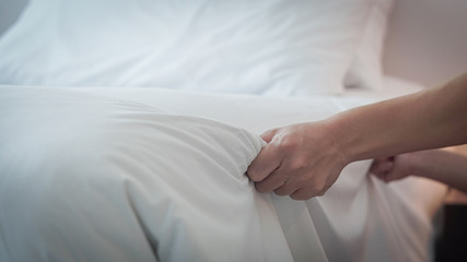 Hands Making Bed from Hotel Room Service