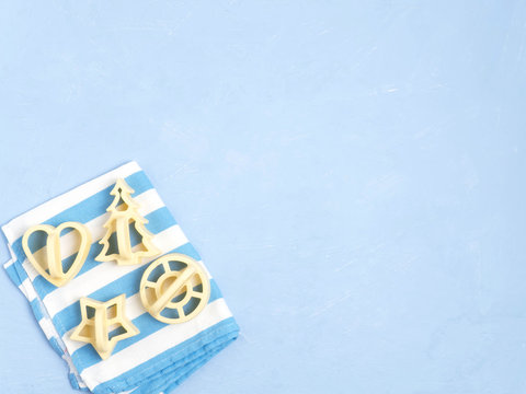 Cookie molds on a towel on a blue background.