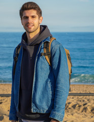 Young stunning man on the sea view 