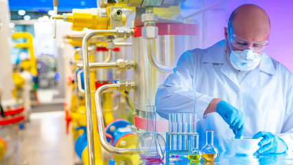 Adult man works in the laboratory. Gas pipes next to the laboratory assistant. Compressor station....