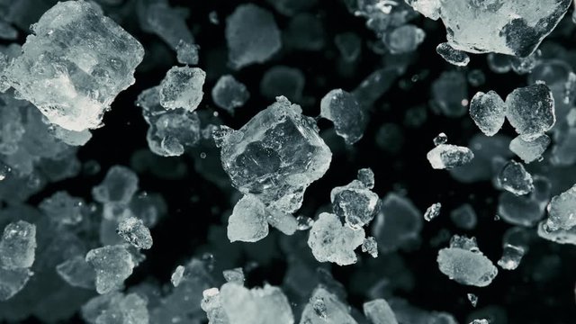 Super Slow Motion of exploding crushed ice towards camera, close-up