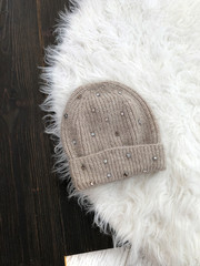 Beige hat on a white fur background