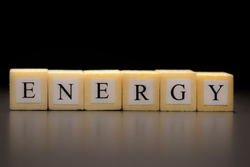 The word ENERGY written on wooden cubes, isolated on a black background...