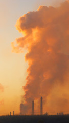 Epic pollution concept. Cloud of harmful substances. Vertical. Metallurgical factory background.