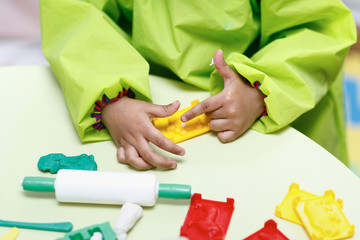 Fototapeta premium Little boy playing with plasticine.