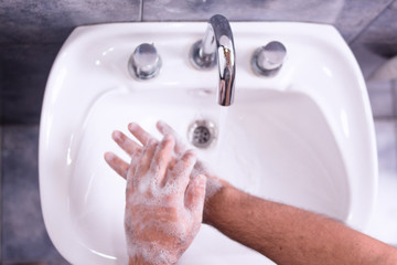 Man washing his hands with neutral soap and water - back foam