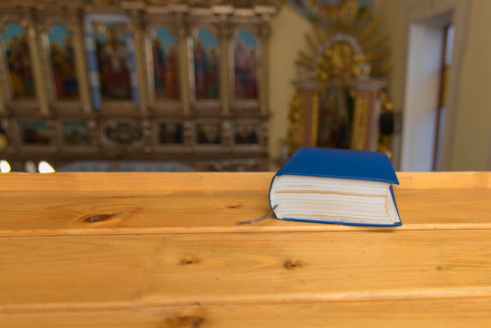 Still photo of bible put on wooden desk in church