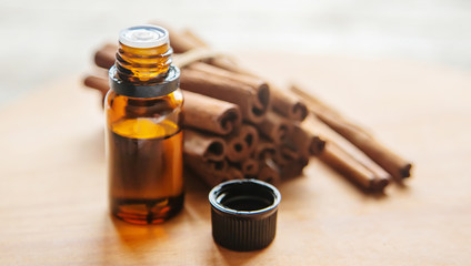 Cinnamon essential oil in a small bottle. Selective focus.