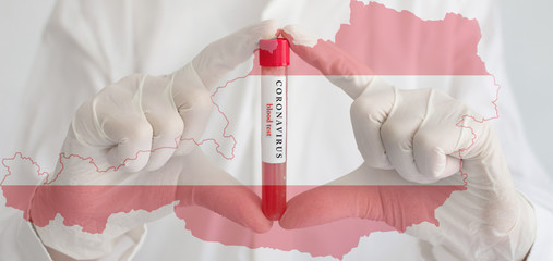 Coronavirus conceptual photo with doctor hands wearing medical gloves holding a blood test result for the COVID-19 pandemic and national flag of Austria, blurred background