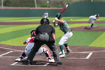 Young boy swinging the bat for a hit in a baseball game