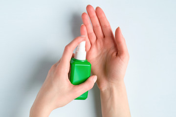 Woman using disinfect hand sanitizer spray. Coronavirus Disease (Covid-19) prevention concept.