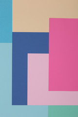 Fototapeta premium Blue, green, yellow and pink background, colored paper geometrically divides into zones, frame, copy, space.