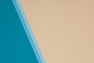 Blue and yellow background, colored paper geometrically divides into zones, frame, copy, space.