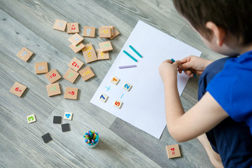 Close-up of children's hands. solving mathematics examples. Educational and school concept. 