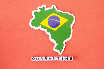 Map of Brazil and word quarantine on a red background. Worldwide pandemic concept.