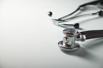 Side view of a medical stethoscope on a blue background